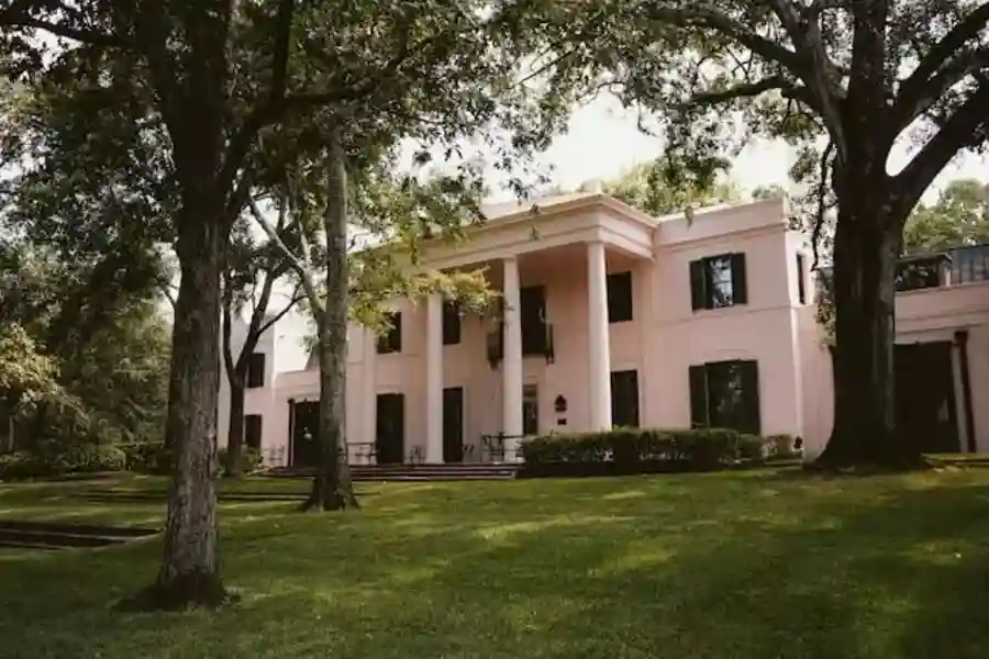 white concrete building near green trees during daytime in Houston city